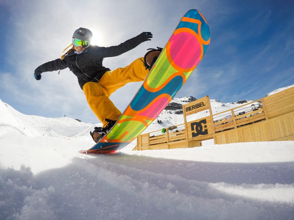 Kid using childrens snowboard hire in Meribel at the DC park